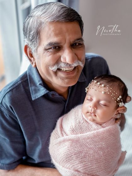 Grandparents are so special. Capturing the joy on a grandfather's face as he holds his new grandchild is a memory to treasure forever.