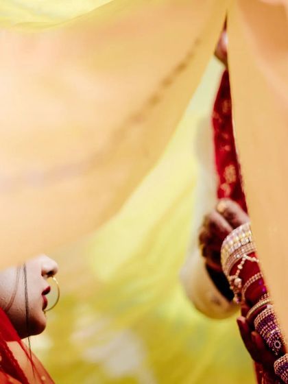 An abstract and artistic view of the Sindoor Daan, captured through layers of fabric. This documentary-style photo plays with composition to evoke the emotion of the moment rather than showing it directly.