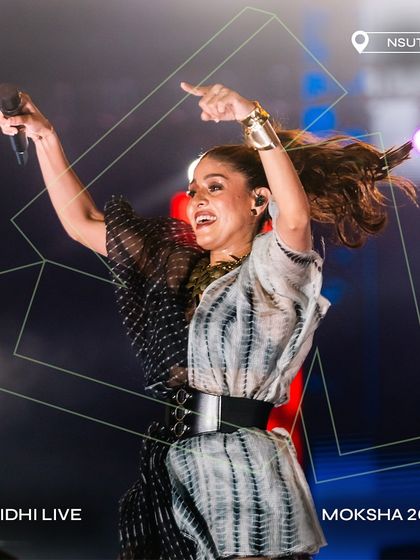 A high-energy shot of Sunidhi Chauhan commanding the stage at Moksha 2024.