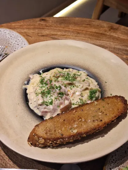 Creamy pasta with garlic bread at La Croute. A classic comfort dish executed perfectly.