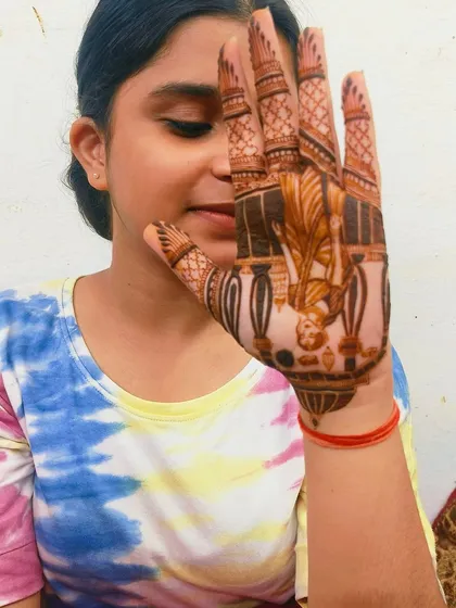 A young client happily showing off her Karva Chauth themed mehandi. I love making designs for all age groups.