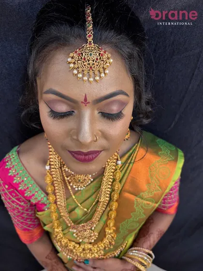 A top-down view showing the flawless makeup application and the intricate details of the bridal attire.