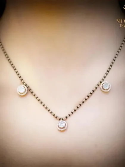 A modern interpretation of the sacred Mangalsutra. This delicate piece features three diamond solitaires set on the traditional black-beaded chain, blending tradition with contemporary design for the modern married woman.