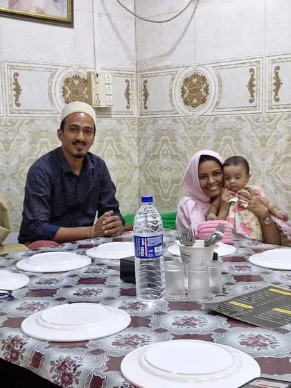 A family seated and ready to enjoy their Iftar meal. I ensure that every group, big or small, gets the best service and a comfortable dining experience.