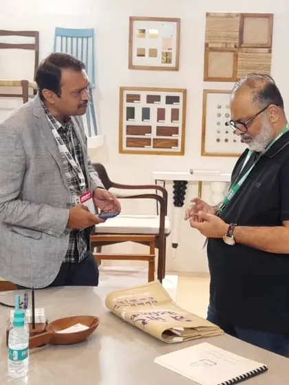 Showing a visitor the different material samples and wood types I work with. This helps them understand the level of customization I offer.