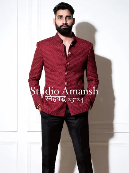 Our crimson bandhgala is crafted to make you stand out. This frontal view highlights the jacket's impeccable fit and the quality of its unique, self-embroidered fabric, perfect for making a lasting impression.