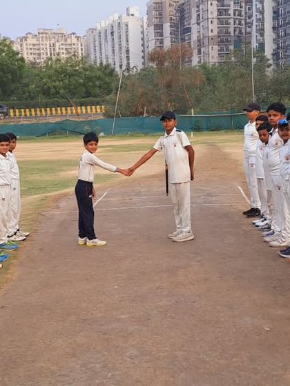 Another shot of the handshake, symbolizing the spirit of cricket. We teach our players to be fierce competitors on the field and gentlemen off it.