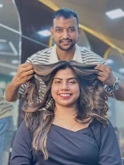 Our artist adding the final touches. This shot captures the fun and energy of a hair transformation session at our studio.
