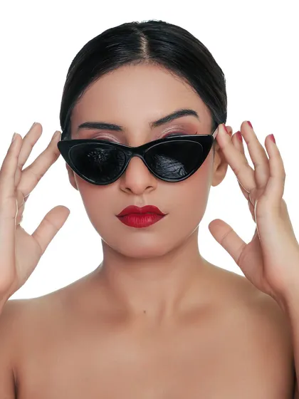 A cool and edgy headshot with cat-eye sunglasses. This look adds a touch of mystery and high fashion to a portfolio, showing versatility.
