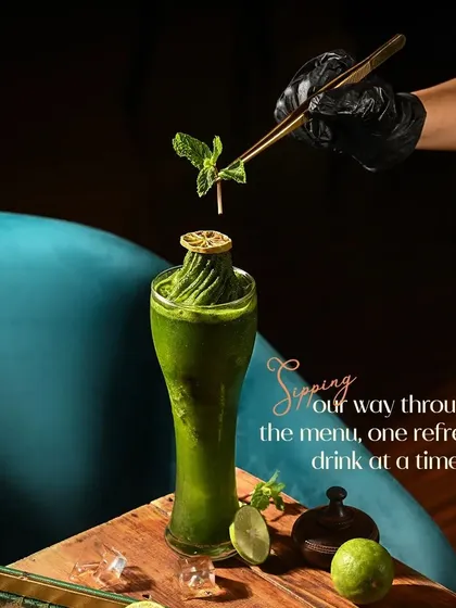 This is our refreshing mint and lime creation, a perfect example of how we use fresh, vibrant ingredients. Each drink is crafted to be a visual delight, garnished with care before it reaches your table.