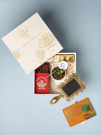 An overhead view of the naming ceremony hamper, showing the custom box, thank you card, and the curated gifts inside.