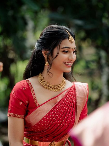 A smiling, happy bride at her engagement. The makeup is designed to enhance her natural glow, making her look radiant and joyful.