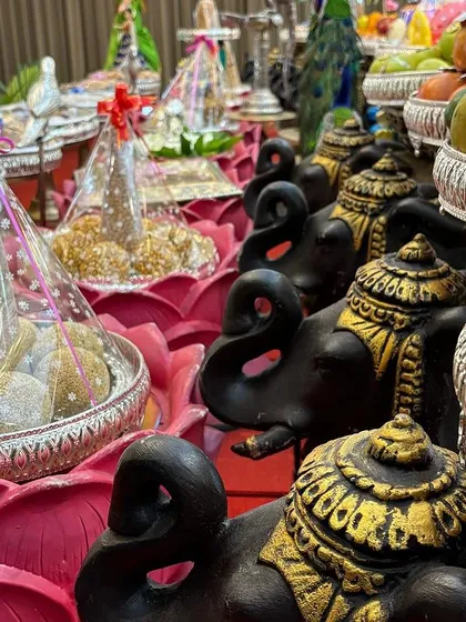 A detailed shot of the offerings, showing the texture and color of the fruits and sweets.