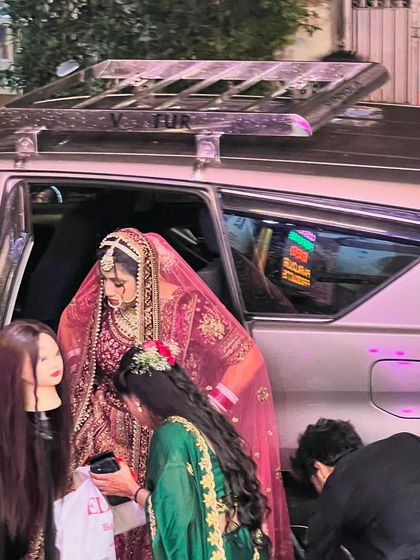 Another shot of our team assisting the bride, ensuring every detail is perfect for her grand entrance. We provide complete support to our brides.