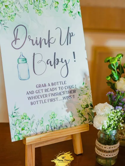 Get ready to 'Drink Up Baby!'. This fun game challenges guests to a bottle-chugging contest. I create these custom signs and set up the station to add another layer of entertainment to your baby shower.