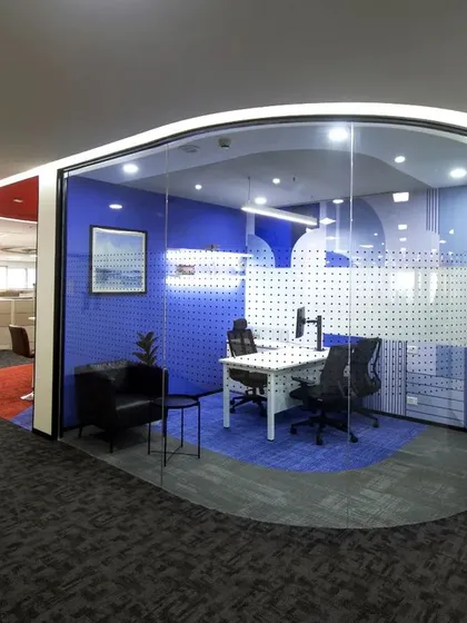 For Scientific Games, we designed this semi-private meeting pod using curved glass walls and a bold blue color scheme. It provides a quiet space for focused discussion while maintaining a visual connection to the open and energetic office environment.
