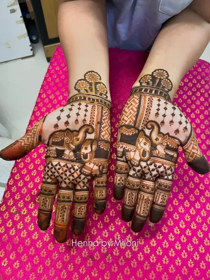 A lovely Karva Chauth mehendi with matching elephant designs on both palms. The intricate details and traditional style are perfect for the festival.