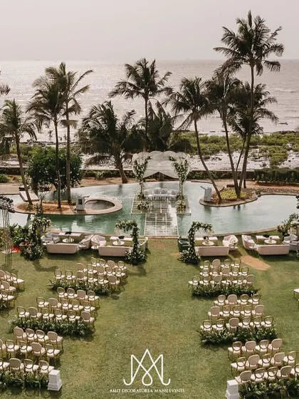 I love crafting breathtaking outdoor weddings. Here, I designed an elegant seaside ceremony with a stunning mandap built over the pool, creating a serene and luxurious atmosphere against the ocean backdrop.