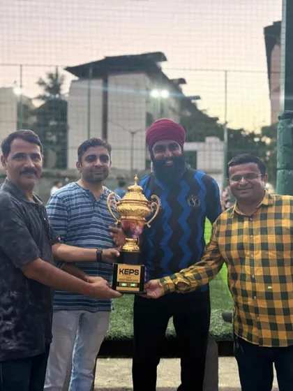 Head Coach Kishan Singh receiving the runner-up trophy on behalf of the U-15 team.