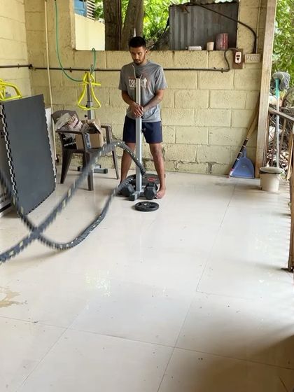 A coach setting up the battle ropes for an upper body workout.
