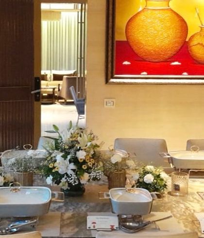 A wide shot of a buffet table set against a backdrop of beautiful art in a client's home, showing how my setup integrates into your space.