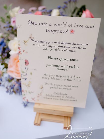 A close-up of the elegant sign at the fragrance station, a romantic and sensory detail for an engagement party.