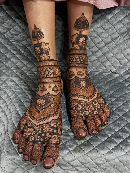 A classic bridal feet design featuring majestic elephants under an umbrella. The lower part of the foot is covered in a dense floral pattern, creating a rich and traditional look.