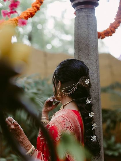 A beautiful, soft-focus shot of a bride from behind, highlighting her elegant hairstyle and the delicate hair jewelry.