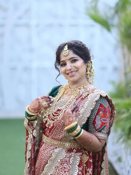 A happy bride on her wedding day. Seeing my customers smile like this is why I started this rental service. She is wearing a traditional red and green bridal Nauvari with a complete jewellery set.