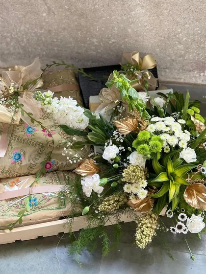 Introducing the art of thoughtful gifting. This bespoke hamper features our finely embroidered shawls, elegantly packaged and paired with fresh florals and decorative elements in a keepsake wooden tray. It represents a perfect gesture for weddings, festive celebrations, or any milestone moment.