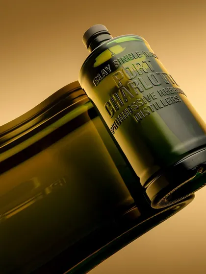 Another view of the "flowing" Port Charlotte bottle concept. This abstract approach turns a simple product into a piece of art, focusing on shape, reflection, and the beautiful olive green of the glass.