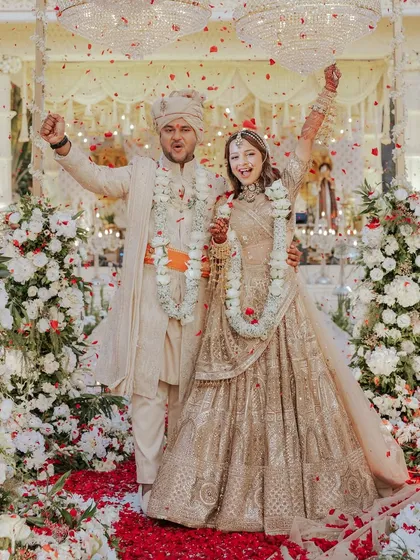 This is what pure joy looks like. For Aashvi and Akash's big day, we created a timeless all-ivory theme. The bride wore a stunning chikankari lehenga by Tarun Tahiliani, and the groom was styled in a coordinated Shantanu & Nikhil sherwani, creating a look of absolute regal elegance.