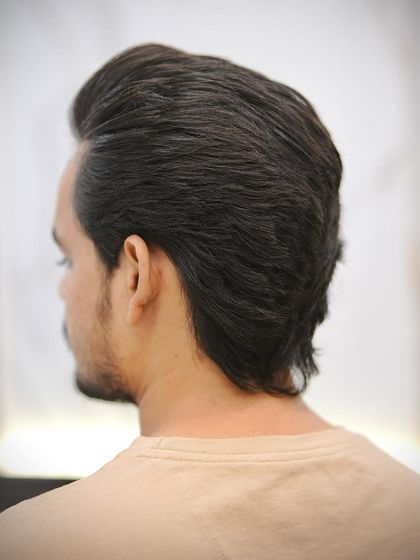 The back of the wolf cut shows off the shaggy layers and texture that define this style.