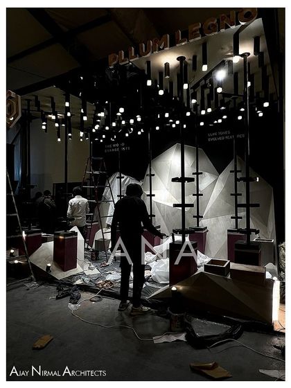 The Pllum Legno installation during the final stages of setup. The lighting grid is in place and protective coverings are still on the floor as our team makes the final adjustments before the show opens.