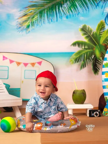 The beach called, so here I am! A happy baby enjoys the sand and surf in our fun and sunny beach camper setup.