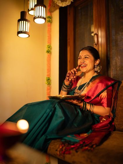 A candid shot filled with laughter during a Diwali celebration. The warm lighting and genuine expression make this a heartwarming capture of festive joy at home.