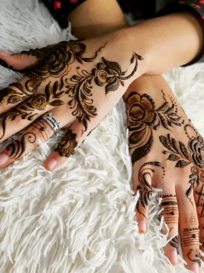 Even a simple design can make a statement. This is a great example of a 'khafif' or Arabic style henna, focusing on flowing floral and vine patterns on the back of the hands for an elegant, minimalist look.