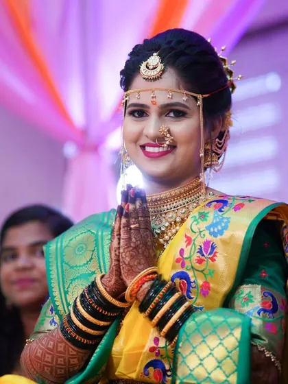 A beautiful portrait of a bride in traditional Marathi wedding attire. We capture the elegance of the Paithani saree, the intricate gold jewelry, and the classic bridal mundavalya.
