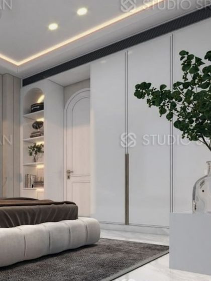 This angle shows the full wall of handle-less wardrobes, which blend into the background and enhance the minimalist aesthetic.