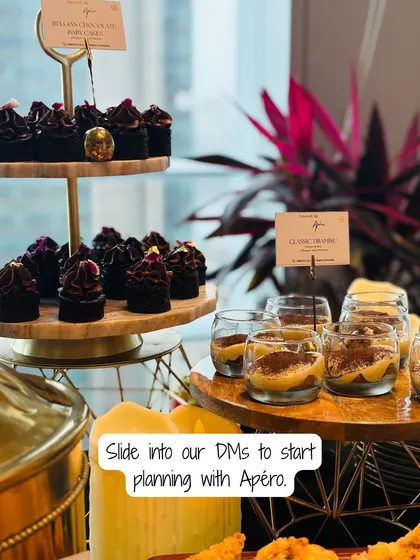 A dessert spread designed to impress. This setup features mini Belgian chocolate cupcakes and individual glasses of classic Tiramisu, perfect for corporate events or elegant parties.