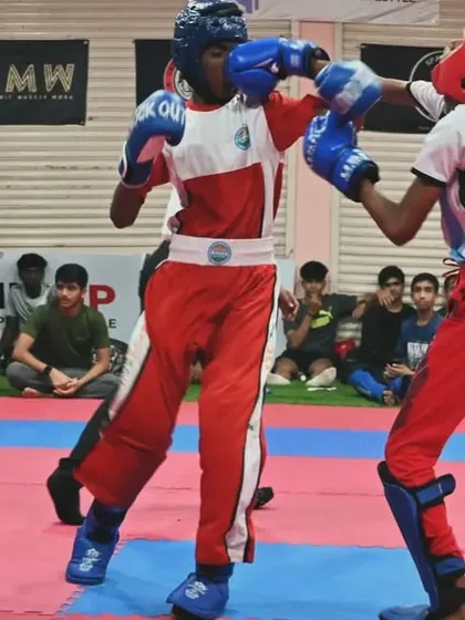 Two young fighters exchange blows in a point fighting match. Our training prepares them for the fast-paced, strategic nature of WAKO-rules kickboxing.