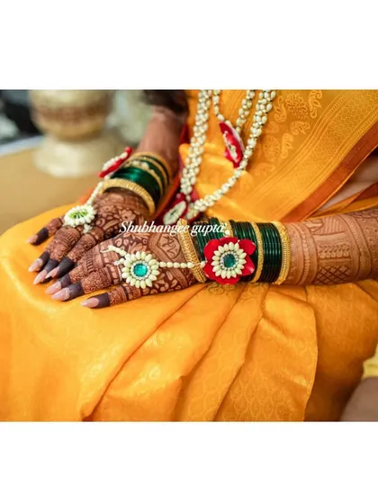 The beautiful henna stain complemented by floral jewelry. The deep color of the mehndi provides a stunning backdrop for all your wedding accessories.