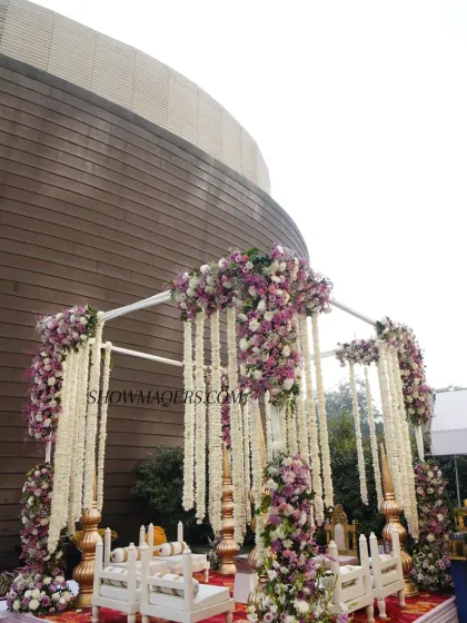 Another angle of the stunning floral mandap, showcasing the intricate details of the hanging garlands and the lush floral pillars.
