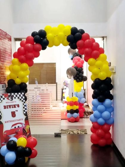A 'Cars' movie themed entrance arch using the signature colors of red, yellow, and black.