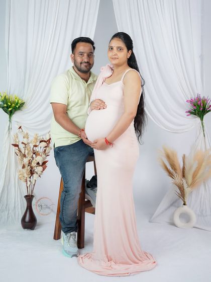 A relaxed and happy portrait of the parents-to-be. Using simple props like a stool allows for comfortable and natural posing during the studio session.