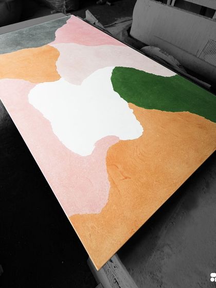 A full view of the custom concrete slab, showcasing the beautiful, abstract composition of colors. This piece is ready to be cut and finished for a client's furniture project.