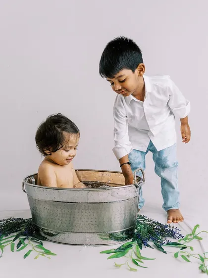 The little brother enjoying his bath while his big brother looks on. These sessions are a great way to capture the sibling bond.
