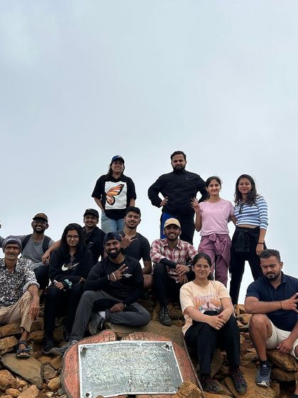 A group of trekkers at the summit of Kudremukha peak, a challenging but highly rewarding climb.