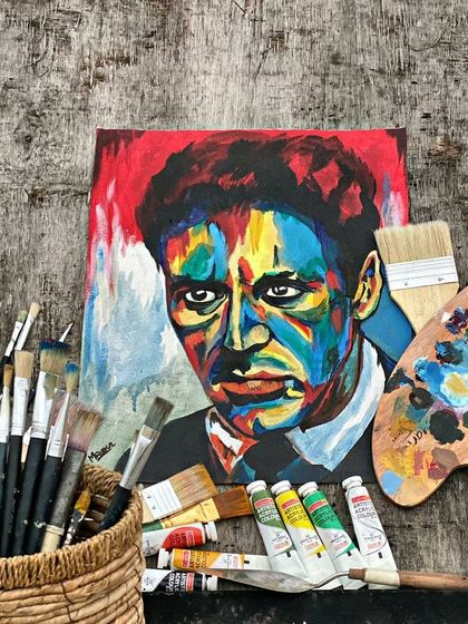 The finished Al Pacino painting, displayed with the tools used to create it. This shows the journey from scattered paints to a cohesive, powerful image.