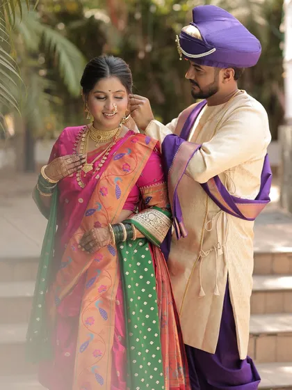 A sweet moment between the couple, with the groom adjusting the bride's earring.
